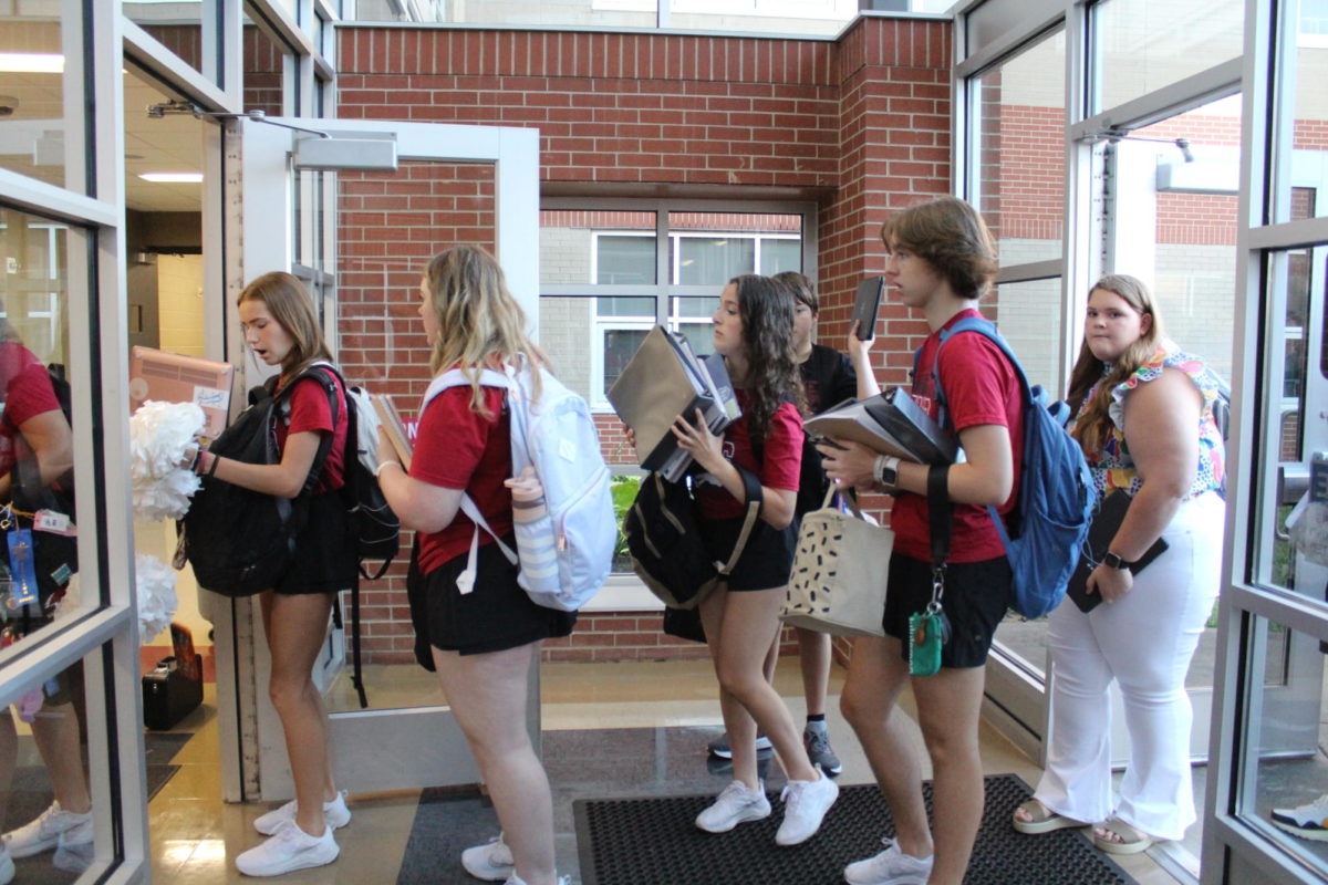 Students prepare for the metal detectors on the first day of school.