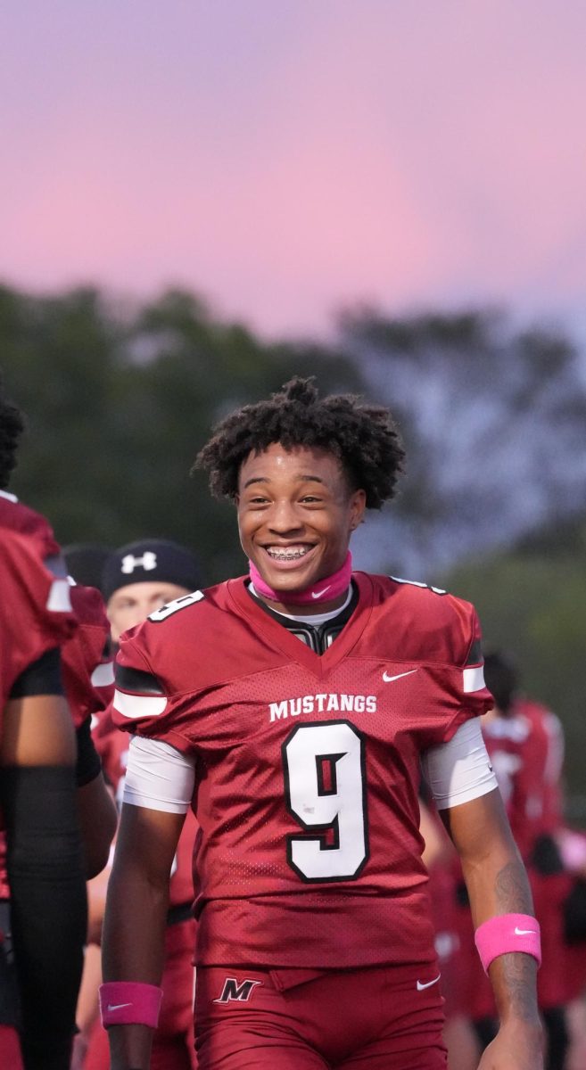 Player 9, player name, walking around to get in line for the player line up before the Mccracken Vs. Christian county game on October 17, at MCHS. This game was special because the seniors had their senior appreciation ceremony before the game. "