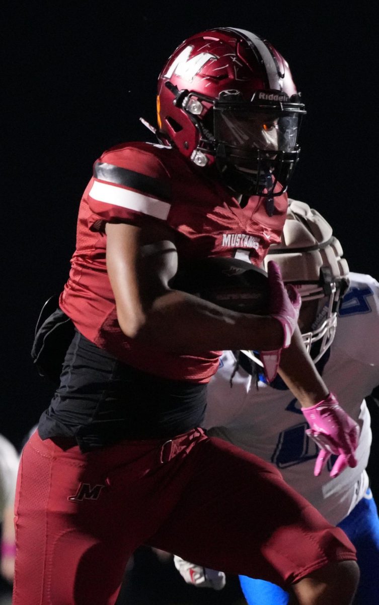 Football player running to get the touchdown during the October 17 Mccracken Vs. Christian Country game. This touchdown was the first touchdown of the game, which lead to the Mustangs winning the football game. "