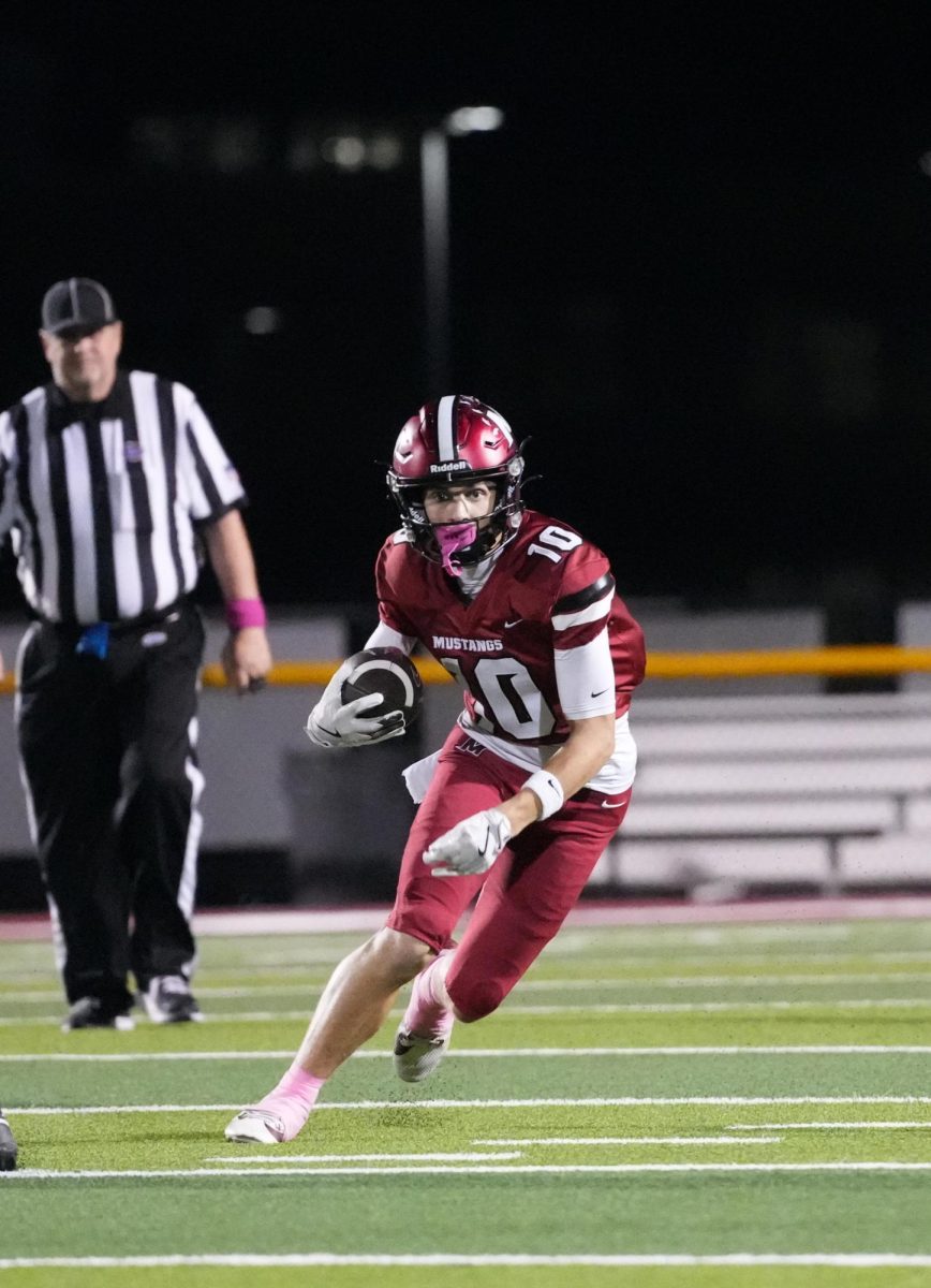 Player number 10 running from the from the opposing team players. Taking the ball a large distance down the field. October 17, 2025 football game against Christian County. 